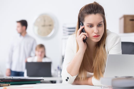 Businesswoman in bad mood talking on the phone