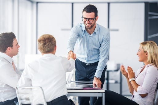 Corporate people shaking hands on a office meeting