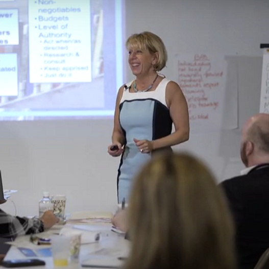 Cyndi Gave speaking to group of leaders