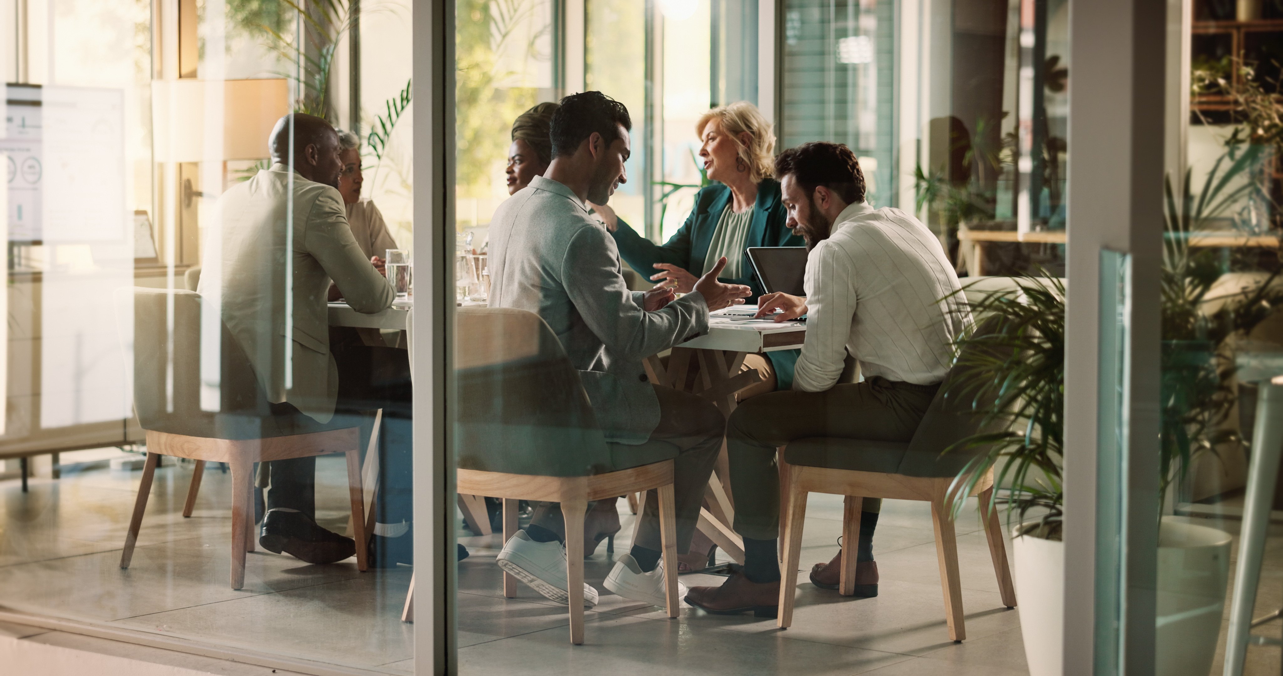 Leaders having meeting at conference table discussing the 2025 leadership trends