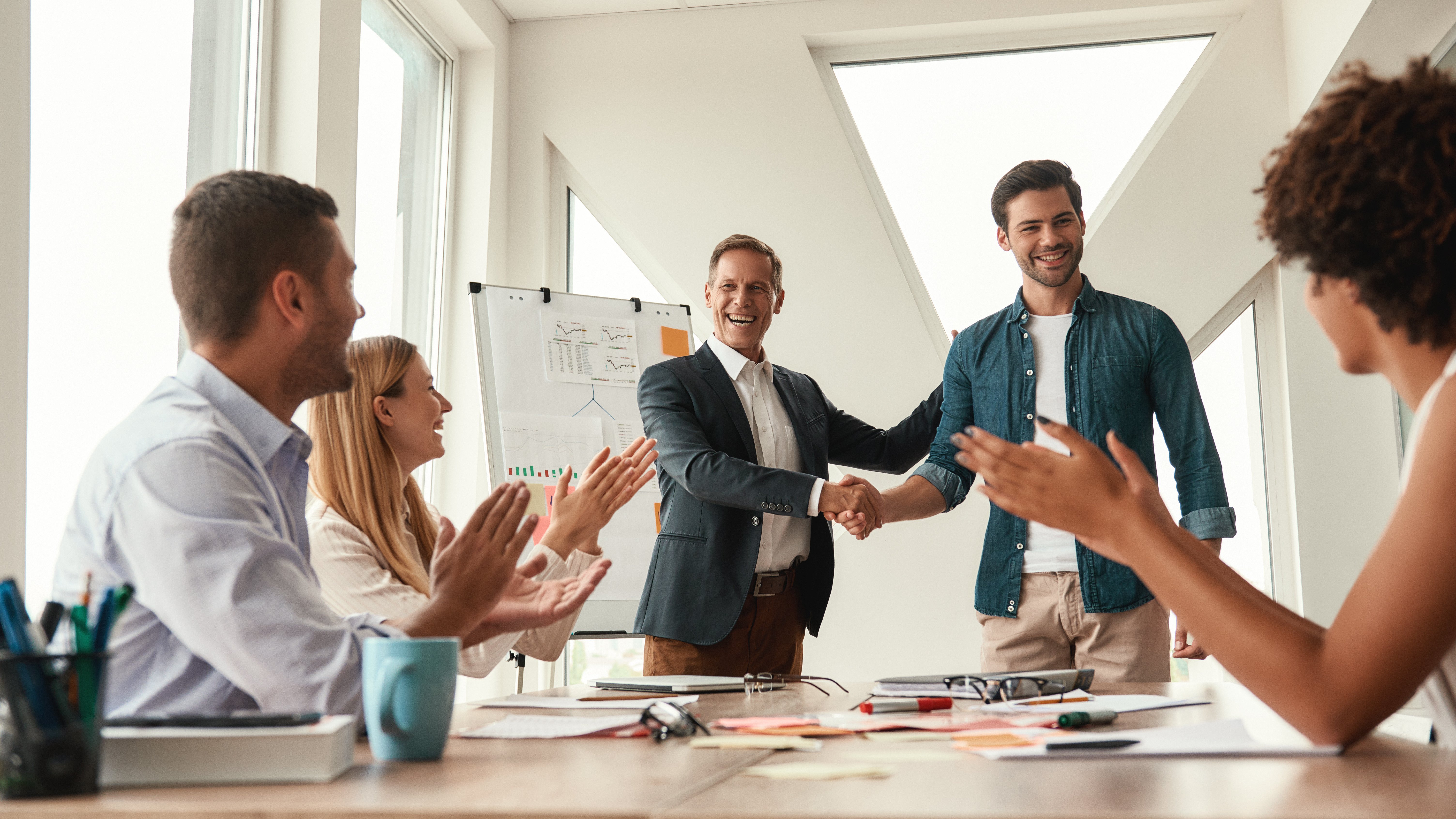 Extroverted leader receiving praise during meeting