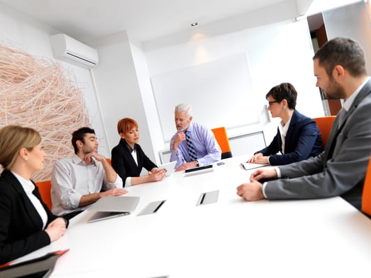 business people group on meeting at modern bright office indoors. Senior businessman as leader in discussion.-1